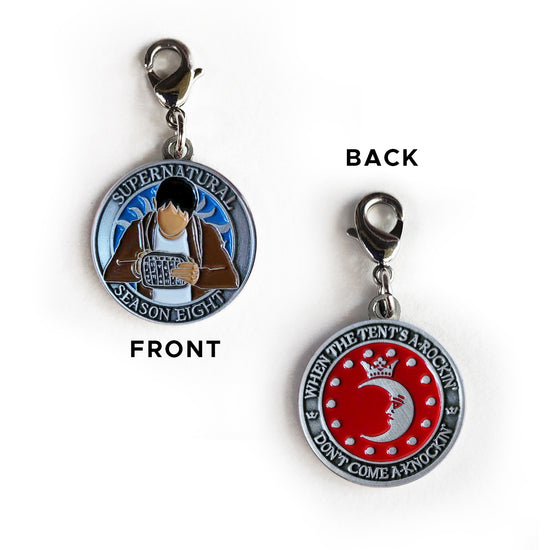 A brass coin with "Supernatural season eight", a blue background, and a sillhouette of Kevin Tran with a tablet on one side, and "When the tent's a-rockin', don't come a-knockin'.", and a silver moon and circle of small silver dots against a red background on the other.
