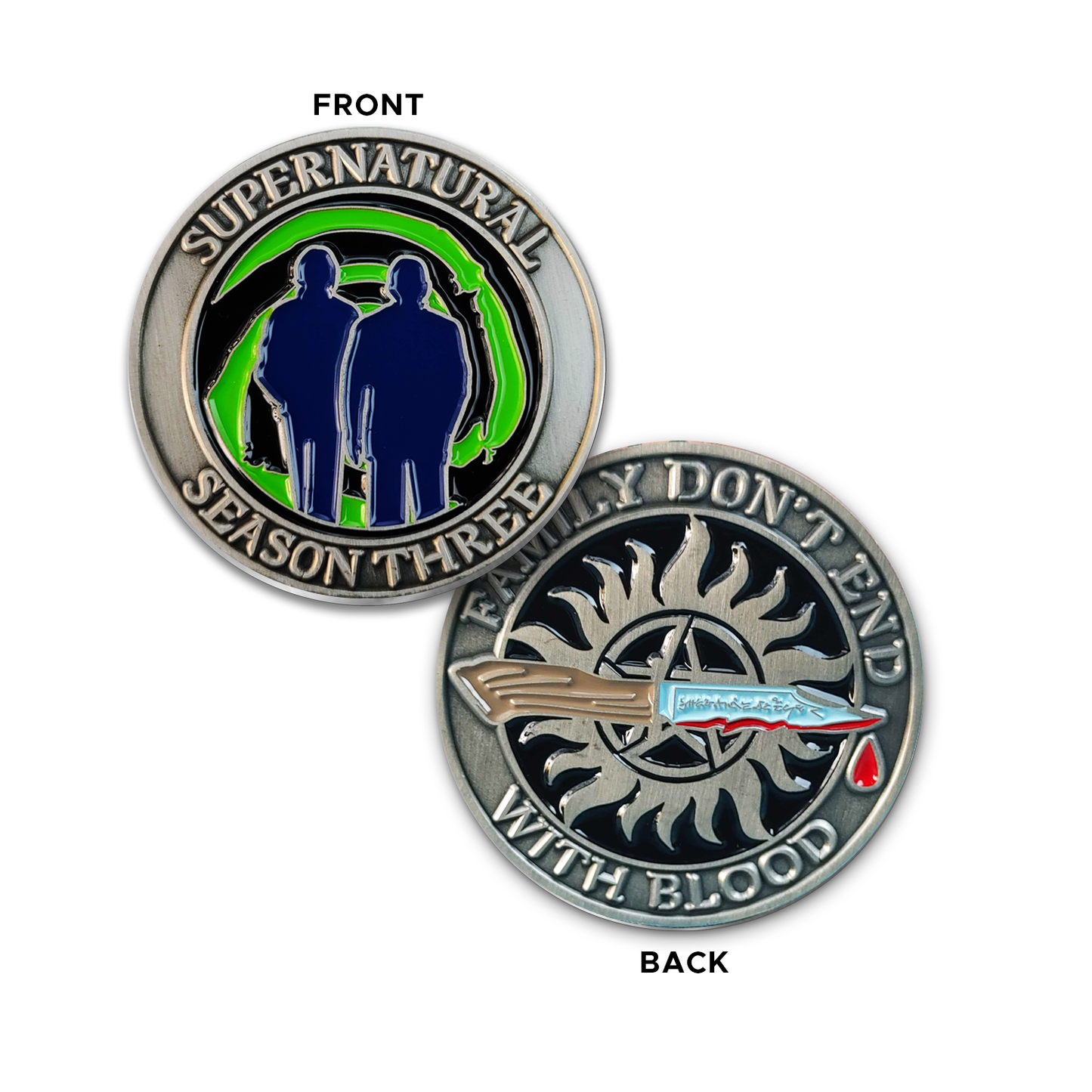 A brass coin with "Supernatural season three", a green "Mystery Spot" swirl, and 2 male sillhouettes on one side and "Family Don't End With Blood" with a knife and anti-possession symbol on the other.